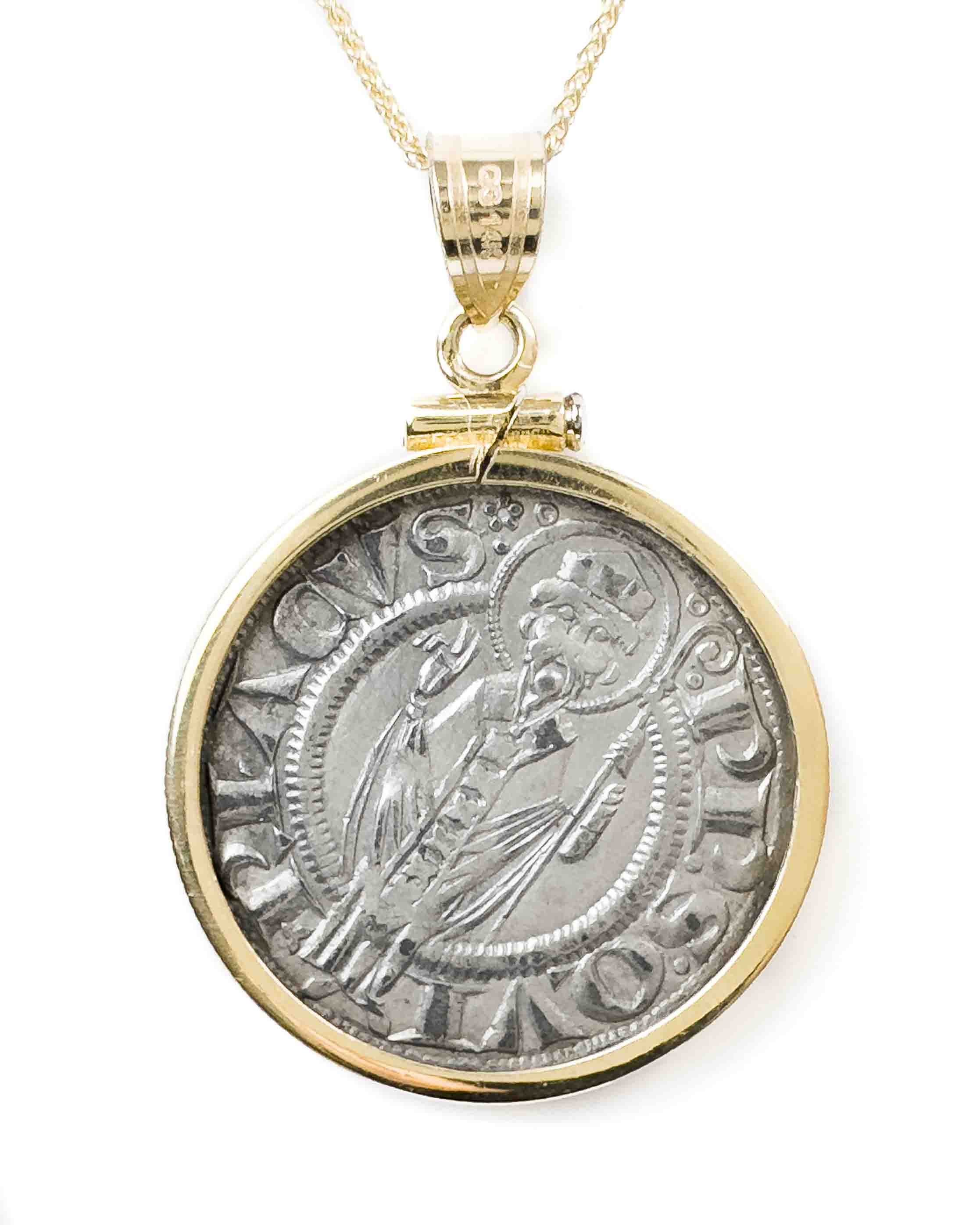 Up close shot of the back of the 14k gold set ancient Italian Grossi coin pendant featuring Saint Cyriacus standing with halo and hand raised.  